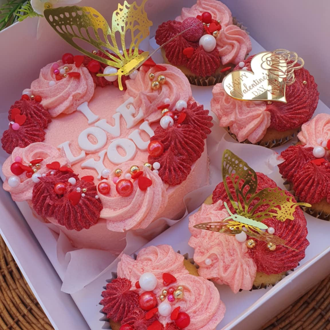 Valentine's Day Cake Bento Box with 'I Love You' cupcakes, colorful butterflies, pink and red sprinkles, and a 'Happy Valentine's Day' message.