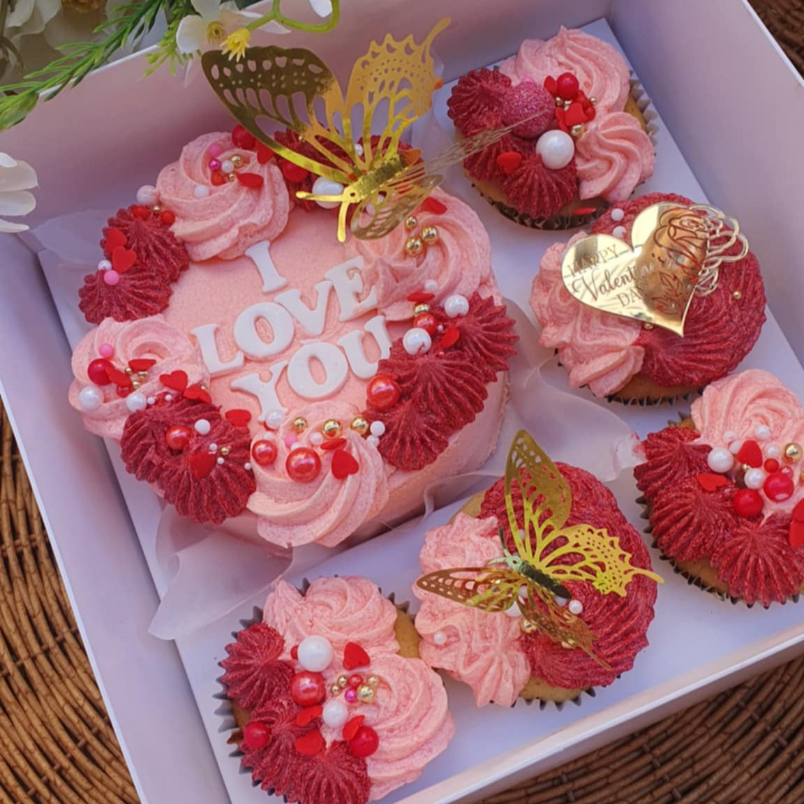 Valentine's Day Cake Bento Box with 'I Love You' cupcakes, colorful butterflies, pink and red sprinkles, and a 'Happy Valentine's Day' message.