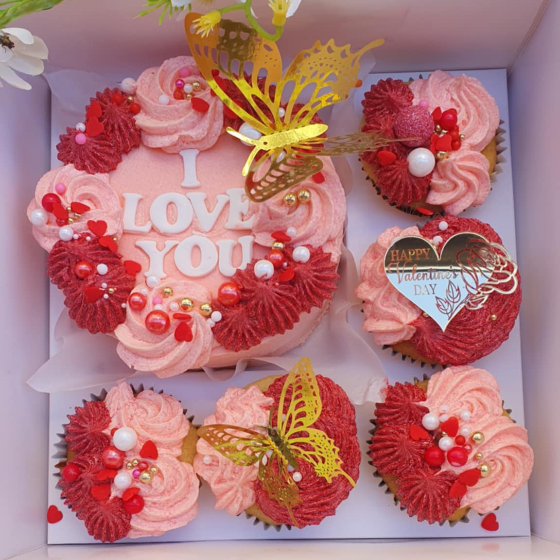 Valentine's Day Cake Bento Box with 'I Love You' cupcakes, colorful butterflies, pink and red sprinkles, and a 'Happy Valentine's Day' message.
